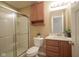 Cozy bathroom featuring a shower with glass door, wooden vanity, and neutral wall colors at 695 Overcup St, Westfield, IN 46074
