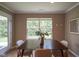 Inviting dining room features a dark wood table, seating for four, and a large window with backyard views at 695 Overcup St, Westfield, IN 46074