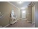 Inviting foyer with carpet, console table, and large mirror that complements the home's design at 695 Overcup St, Westfield, IN 46074