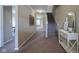 Welcoming foyer with staircase, carpeted floors, elegant console table, and neutral paint at 695 Overcup St, Westfield, IN 46074