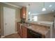 Kitchen features brown cabinets, stainless steel sink, brown countertops, and pendant lighting at 695 Overcup St, Westfield, IN 46074