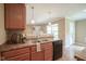 Kitchen features brown cabinets, stainless steel sink, brown countertops, and view to the living room at 695 Overcup St, Westfield, IN 46074