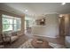 Open-concept living area with views into dining and kitchen areas, filled with natural light at 695 Overcup St, Westfield, IN 46074
