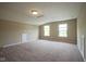 Bright, open living room featuring three windows and carpeted floor at 695 Overcup St, Westfield, IN 46074