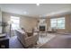 Bright living room with a fireplace, large windows, and cozy furniture, perfect for relaxing at 695 Overcup St, Westfield, IN 46074