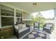 Inviting covered patio with wicker furniture, perfect for relaxing and enjoying the outdoors at 695 Overcup St, Westfield, IN 46074