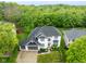 Stunning aerial view of a white house with a dark gray roof and lush green surroundings at 7022 Tamarind Ct, Indianapolis, IN 46236