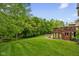 A well-manicured backyard with a spacious lawn and a charming deck area at 7022 Tamarind Ct, Indianapolis, IN 46236