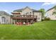 Large backyard with deck and patio seating area featuring a fire pit at 7022 Tamarind Ct, Indianapolis, IN 46236