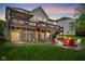 Expansive backyard with a multi-level deck, string lights, fire pit, and outdoor seating at 7022 Tamarind Ct, Indianapolis, IN 46236