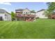 An expansive backyard with a deck, patio, seating, and fire pit at 7022 Tamarind Ct, Indianapolis, IN 46236