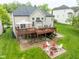 Two-level deck in the backyard with a patio, firepit, and lush green lawn at 7022 Tamarind Ct, Indianapolis, IN 46236