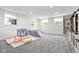 Spacious basement playroom with plush carpeting, play structure, and built-in shelving at 7022 Tamarind Ct, Indianapolis, IN 46236