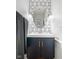 Chic bathroom with patterned wallpaper, modern vanity, and elegant mirror at 7022 Tamarind Ct, Indianapolis, IN 46236