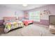 This playful bedroom features two twin beds and cheerful unicorn wall decor at 7022 Tamarind Ct, Indianapolis, IN 46236