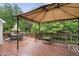 Covered deck with outdoor dining set and views of the wooded backyard at 7022 Tamarind Ct, Indianapolis, IN 46236