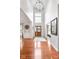 Elegant foyer with a high ceiling, hardwood floors, and a decorative front door with wreath at 7022 Tamarind Ct, Indianapolis, IN 46236