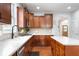 Well-equipped kitchen features white countertops, wood cabinets, and a modern faucet at 7022 Tamarind Ct, Indianapolis, IN 46236