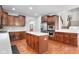 Modern kitchen with stainless appliances, white countertops, and rich wood cabinetry at 7022 Tamarind Ct, Indianapolis, IN 46236