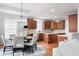 Open concept kitchen with rich wood cabinetry, stainless steel appliances, and an adjacent dining area at 7022 Tamarind Ct, Indianapolis, IN 46236
