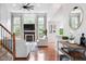 Open-concept living room with a fireplace, large windows, and modern furnishings at 7022 Tamarind Ct, Indianapolis, IN 46236
