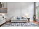 Stylish living room featuring hardwood floors, a sofa, and elegant wall paneling at 7022 Tamarind Ct, Indianapolis, IN 46236
