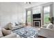 Bright living room featuring a fireplace, large windows, and a comfortable seating arrangement at 7022 Tamarind Ct, Indianapolis, IN 46236
