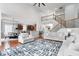 Open living space with hardwood floors and access to the kitchen, dining area, and staircase at 7022 Tamarind Ct, Indianapolis, IN 46236