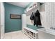 Charming mudroom with practical storage solutions, tiled floor, and accent wall at 7022 Tamarind Ct, Indianapolis, IN 46236