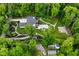 A high angle view of the home set amidst a landscape complete with mature trees and pool at 7070 Dean Rd, Indianapolis, IN 46220