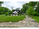 Serene backyard with a decorative rock creek, in-ground pool, and lush greenery, offering a peaceful and private outdoor retreat at 7070 Dean Rd, Indianapolis, IN 46220
