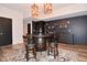 Entertainment area features a unique barrel table with seating, and a bar with sink and floating shelves at 7070 Dean Rd, Indianapolis, IN 46220
