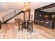 Basement space with a full bar, unique barrel table, and seating, plus a staircase for upstairs access at 7070 Dean Rd, Indianapolis, IN 46220
