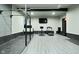 Finished basement gym area with equipment, grey tones, and updated flooring at 7070 Dean Rd, Indianapolis, IN 46220