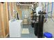 Spacious basement with laundry area, water filtration and other utility features at 7070 Dean Rd, Indianapolis, IN 46220