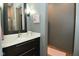 Bathroom with dark wood vanity, a marble countertop, a toilet, and modern lighting at 7070 Dean Rd, Indianapolis, IN 46220