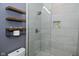 Shower with light grey tiled walls, a glass enclosure, and built-in niche at 7070 Dean Rd, Indianapolis, IN 46220