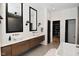 Bathroom featuring a double sink vanity, soaking tub, and tiled floors at 7070 Dean Rd, Indianapolis, IN 46220