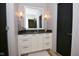 Elegant bathroom featuring modern fixtures, a vanity, and sconces at 7070 Dean Rd, Indianapolis, IN 46220