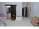 bedroom with a black sliding door to the bathroom, a crib, and a toy kitchen set at 7070 Dean Rd, Indianapolis, IN 46220