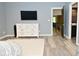 Modern bedroom with a dresser, TV, and an open doorway to the rest of the home at 7070 Dean Rd, Indianapolis, IN 46220