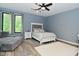 Stylish bedroom with a plush chaise lounge, comfortable bed, and natural light from the window at 7070 Dean Rd, Indianapolis, IN 46220