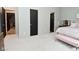 Bedroom with neutral carpet and walls with a pink bench seat to the bed at 7070 Dean Rd, Indianapolis, IN 46220