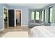 Bedroom with large windows, a comfortable lounge chair, and access to the en-suite bathroom at 7070 Dean Rd, Indianapolis, IN 46220