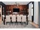 Elegant dining room with a long table, stylish chairs, wine rack, and bar at 7070 Dean Rd, Indianapolis, IN 46220
