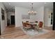 Inviting dining room area with modern chandelier and rustic wood flooring at 7070 Dean Rd, Indianapolis, IN 46220