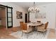 Elegant dining room featuring a stylish chandelier, a round table, and seating for six at 7070 Dean Rd, Indianapolis, IN 46220