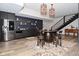 Entertaining space features a stainless refrigerator, wet bar, unique barrel table and seating, and staircase at 7070 Dean Rd, Indianapolis, IN 46220