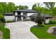 Stunning exterior showcases modern design, stone accents, sleek garage door, and a spacious driveway at 7070 Dean Rd, Indianapolis, IN 46220
