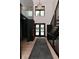 Inviting foyer featuring a staircase, wood floors, chandelier, and front door at 7070 Dean Rd, Indianapolis, IN 46220